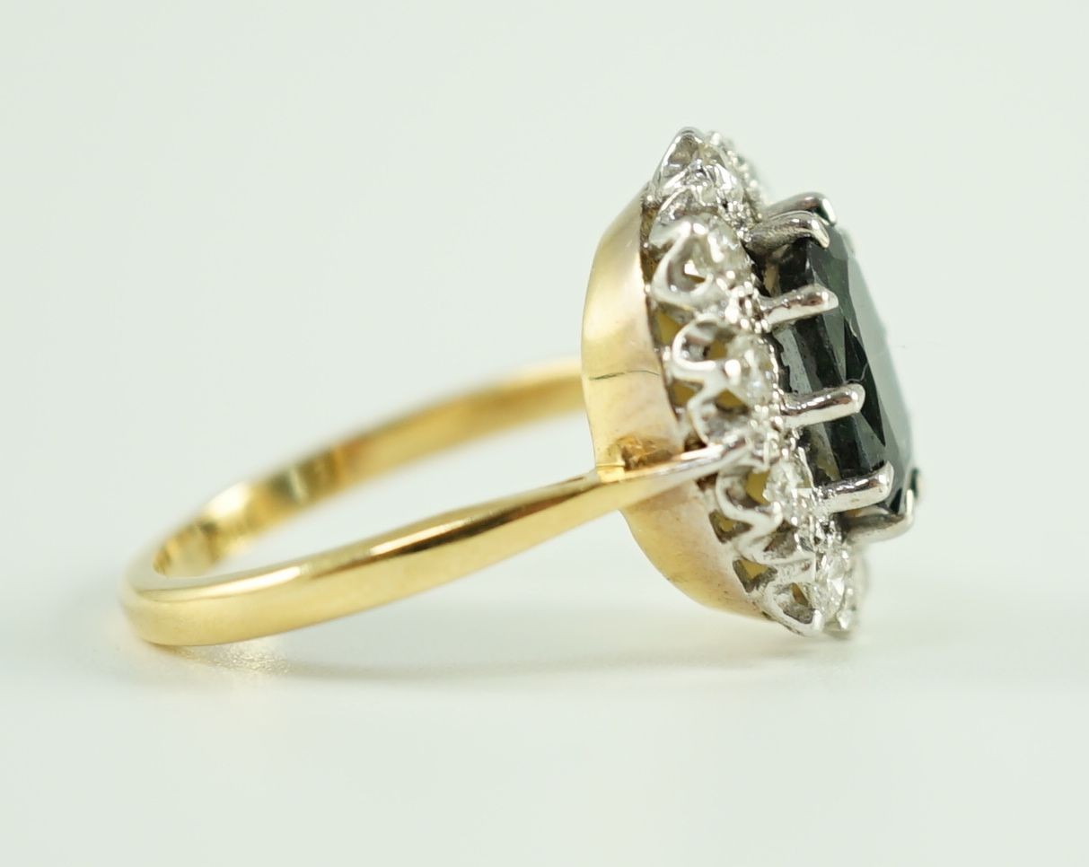 An 18ct gold, sapphire and diamond set oval cluster dress ring